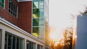 The sun sets on a campus building.