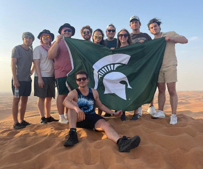 Group of students displaying Spartan flag.