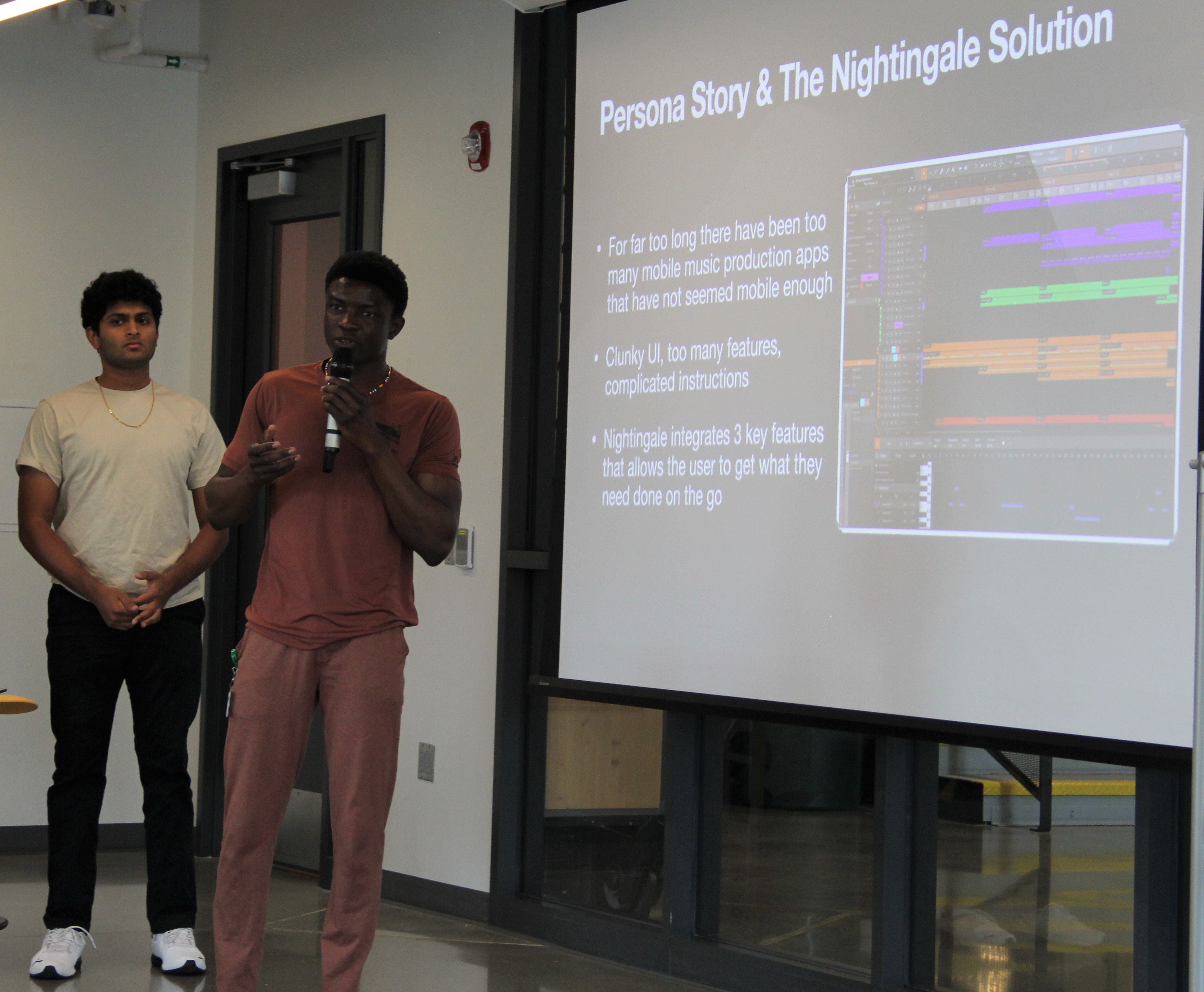 Student standing in front of screen presenting