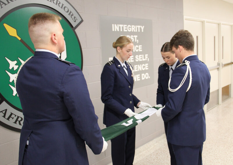 U.S. Air Force ROTC cadets folding Spartan flags