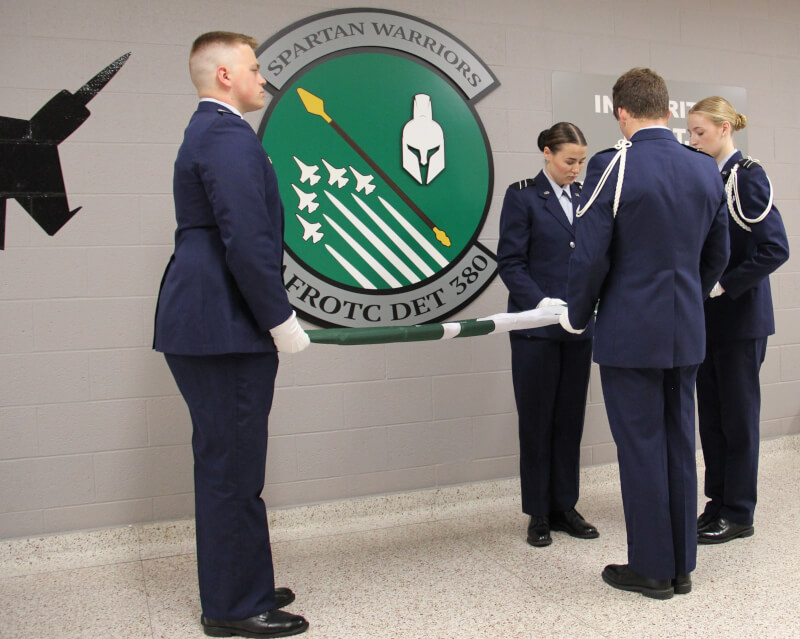 U.S. Air Force ROTC cadets folding Spartan flags