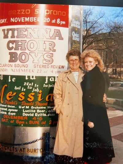 Amy Martin standing next to another individual and a large display of signs