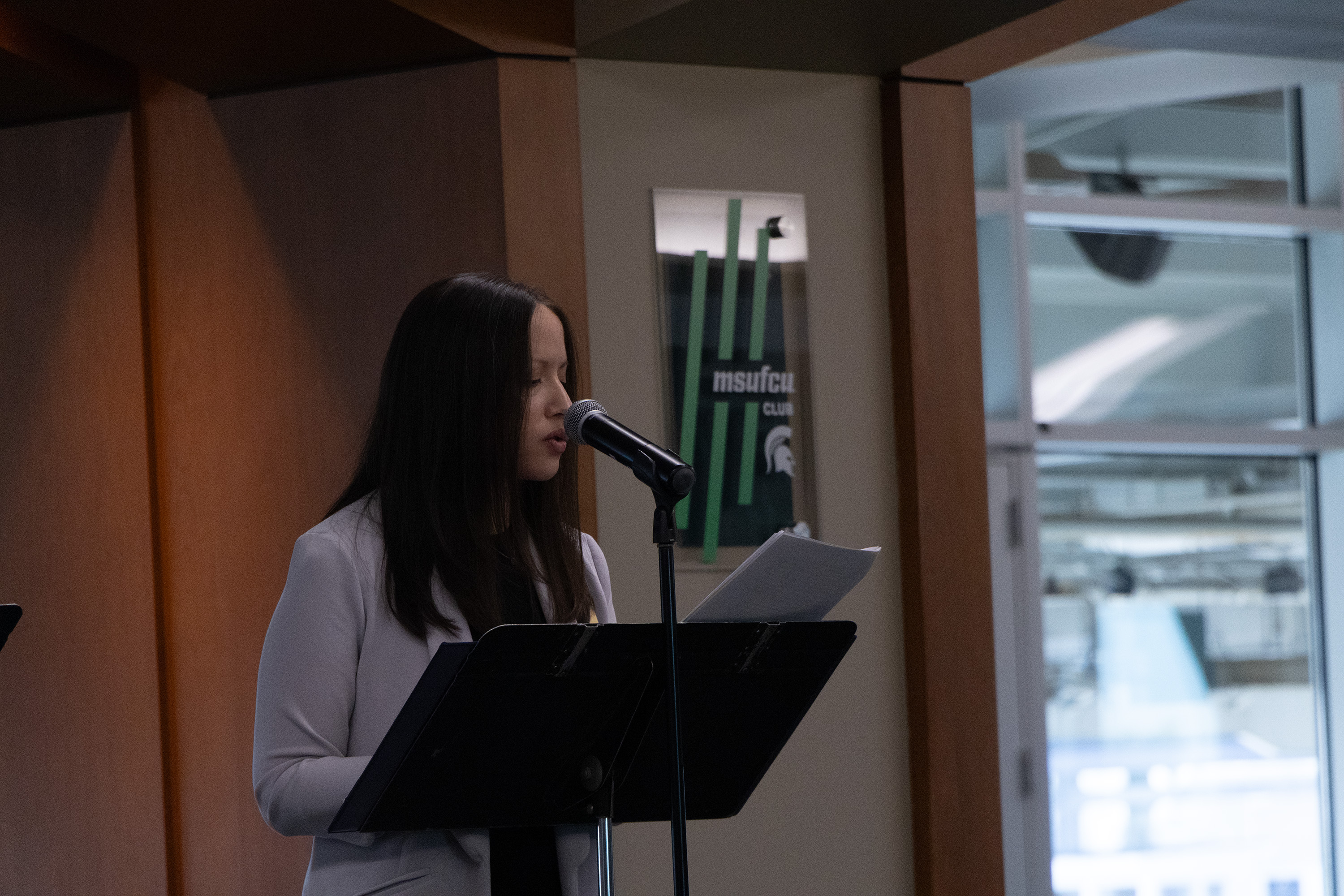 Maria O'Connell, University Innovation Alliance Fellow and Undergraduate Student Success Strategic Initiatives Manager, speaks at the podium at the 2024 Student Success Launch.