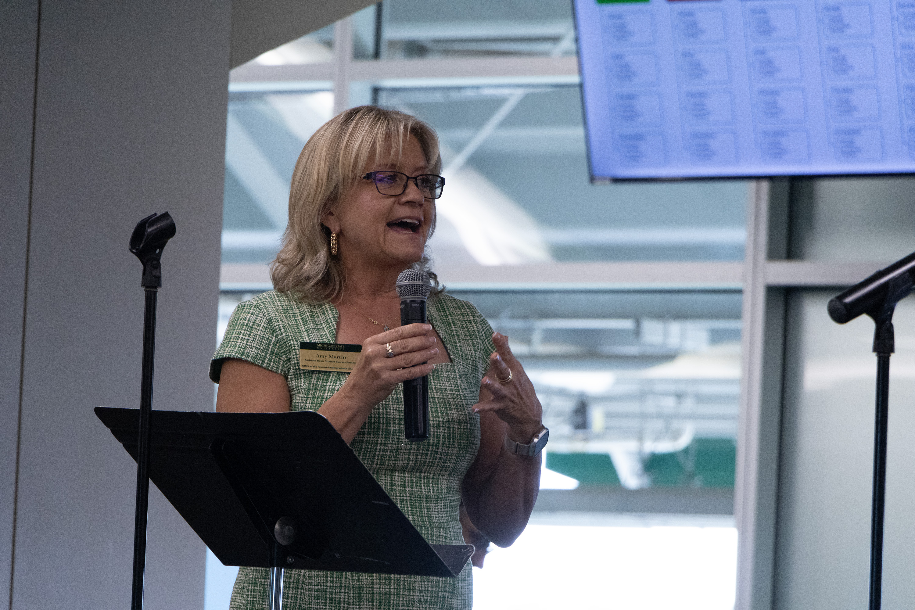Amy Martin, Assistant Dean of Student Success Strategy, speaks at the podium at the 2024 Student Success Launch.