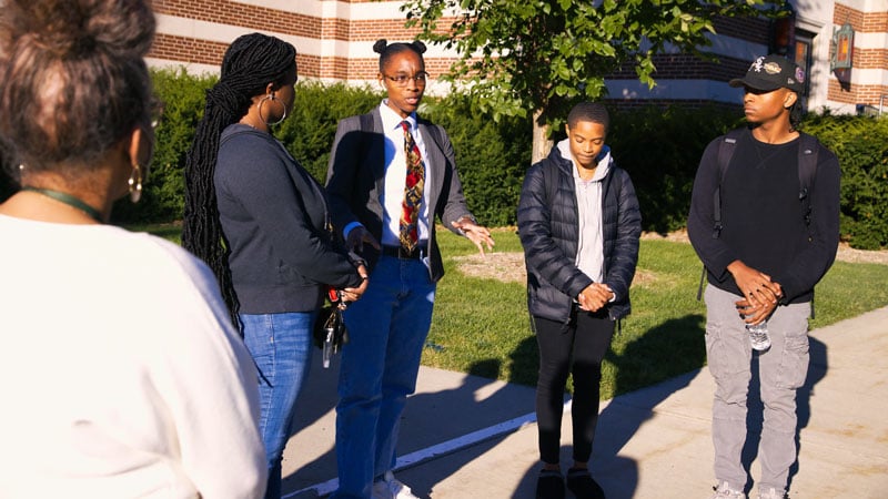 African American studies students stand in a group outside on campus.