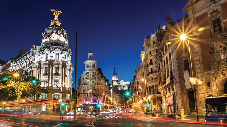 View of a student pursuing a degree in Spanish on education abroad ? golden streetlights illuminate a Spanish city at night.