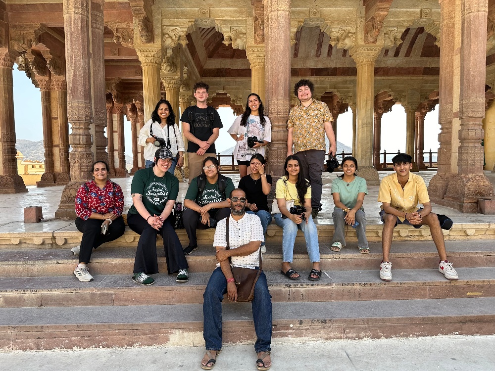 A group of MSU students studying interdisciplinary studies in social science posing on the steps of the Amber Fort in India.