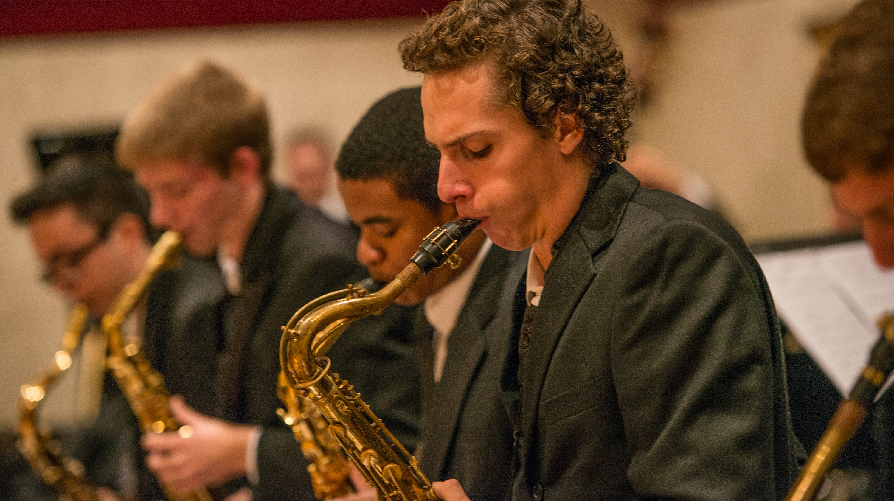A row of jazz majors play saxophones.