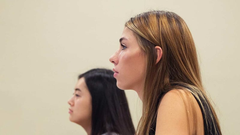 The profiles of two management majors looking forward and listening attentively.