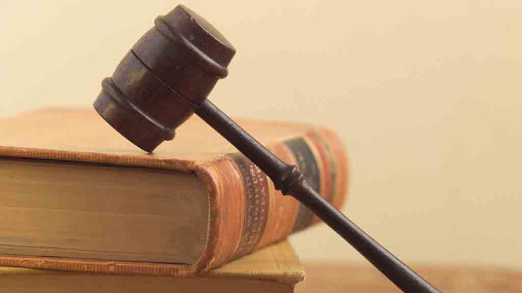 Close-up of stacked legal texts and a gavel, representing the political science prelaw major.