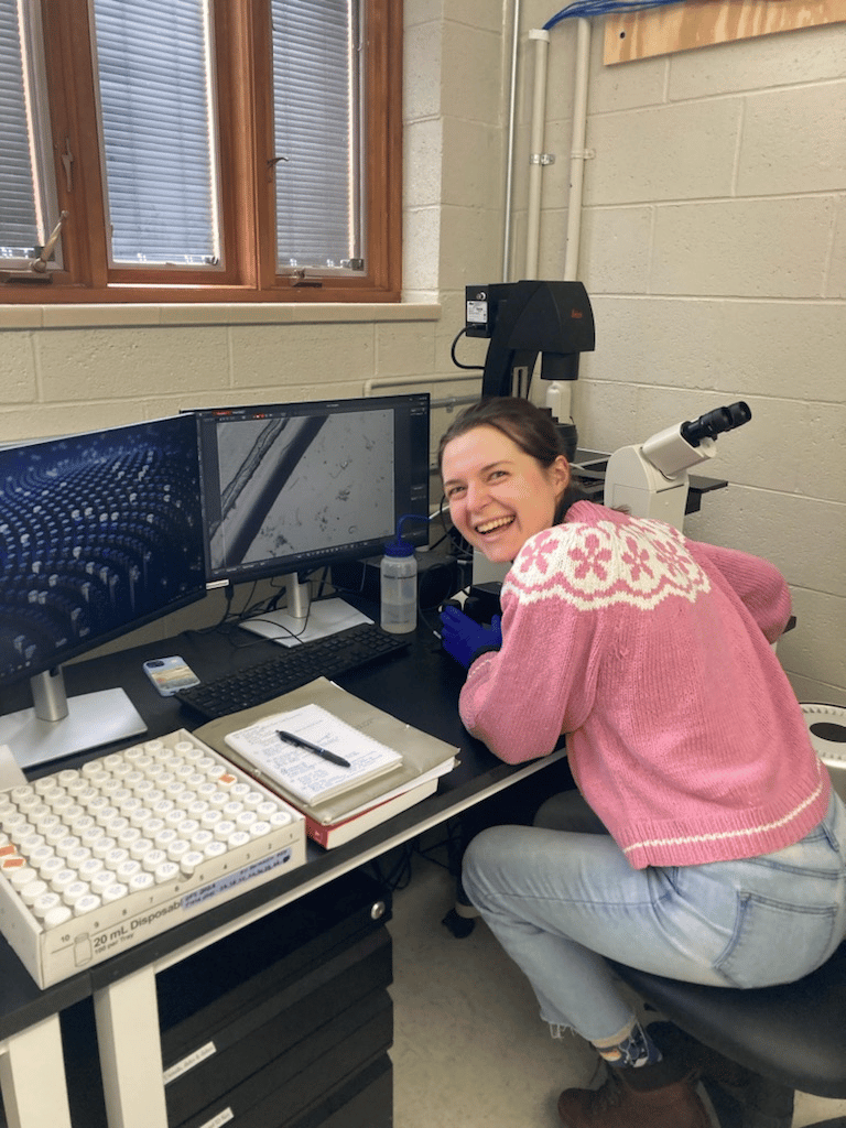 An aspiring agronomist and Michigan State University Crop and Soil Sciences graduate student analyzes soil samples in a laboratory, using microscopy and digital imaging tools to study soil health and agricultural conservation practices.