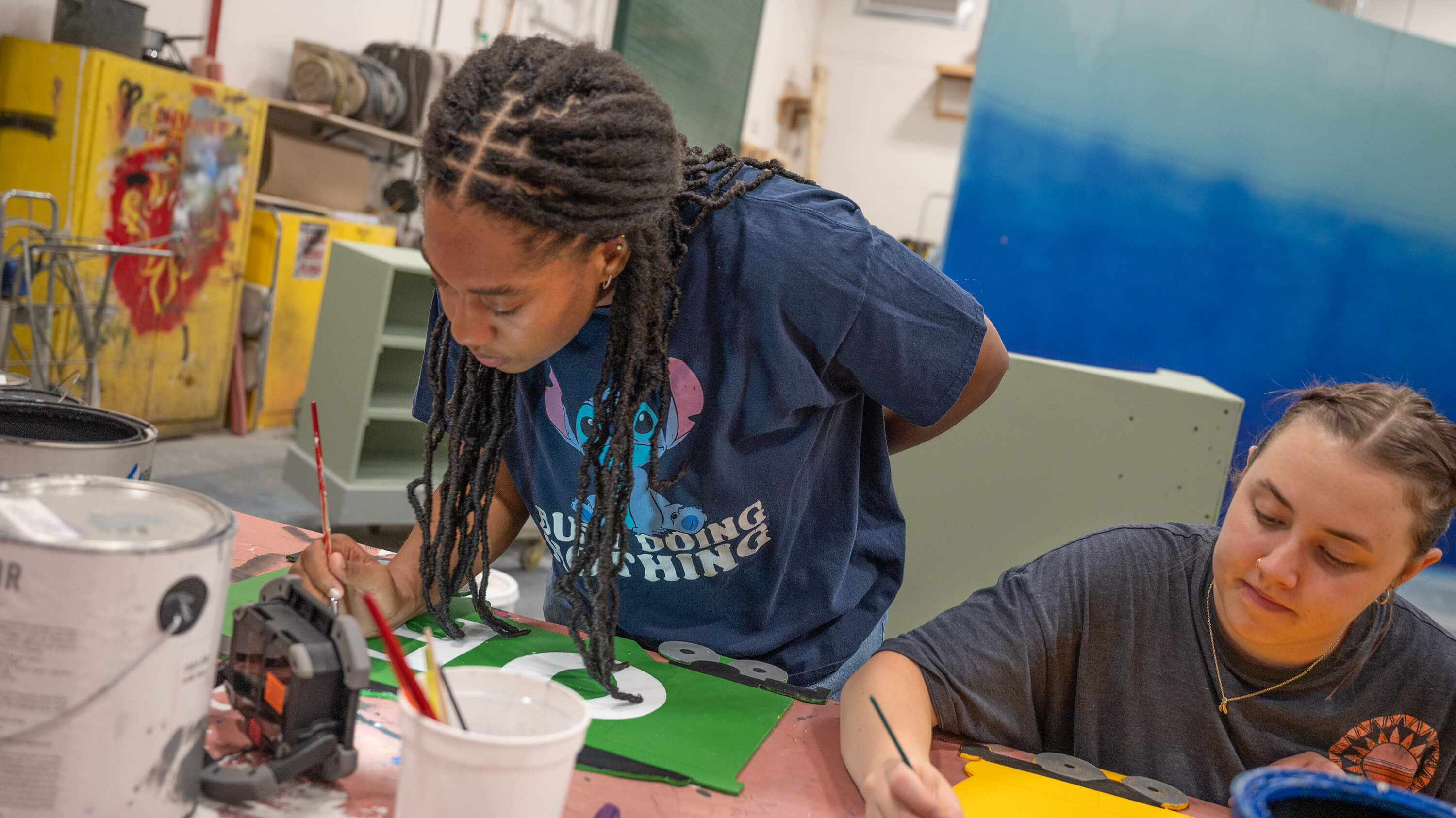 Two students crafting set pieces and props in the MSU Scene Shop.