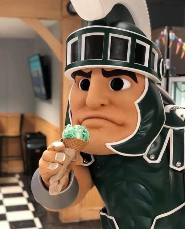 MSU mascot, Sparty, holding an ice cream cone at the MSU Dairy Store.