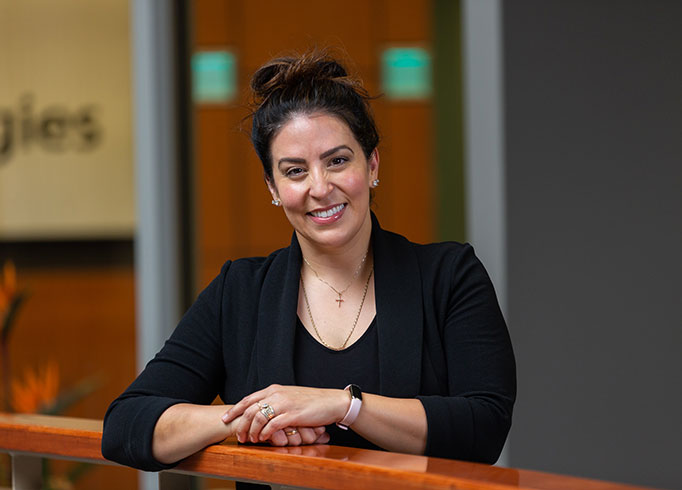 Desireé Melfi Bozzo, director of advising and student success, poses in black power suit