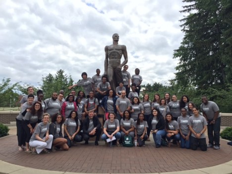 Group of students around Sparty statue.