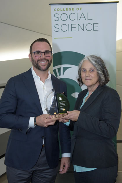 Nick Nefuse receives his award from Dean Mary Finn.
