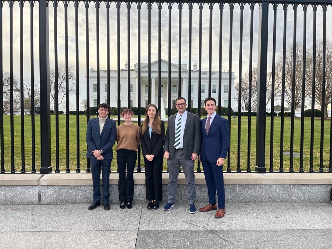 Fed challenge students and professor stand in front of the White House.