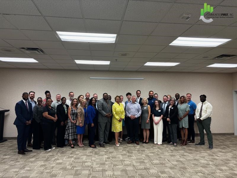 Aaron Shapo stands with a large group of community members.