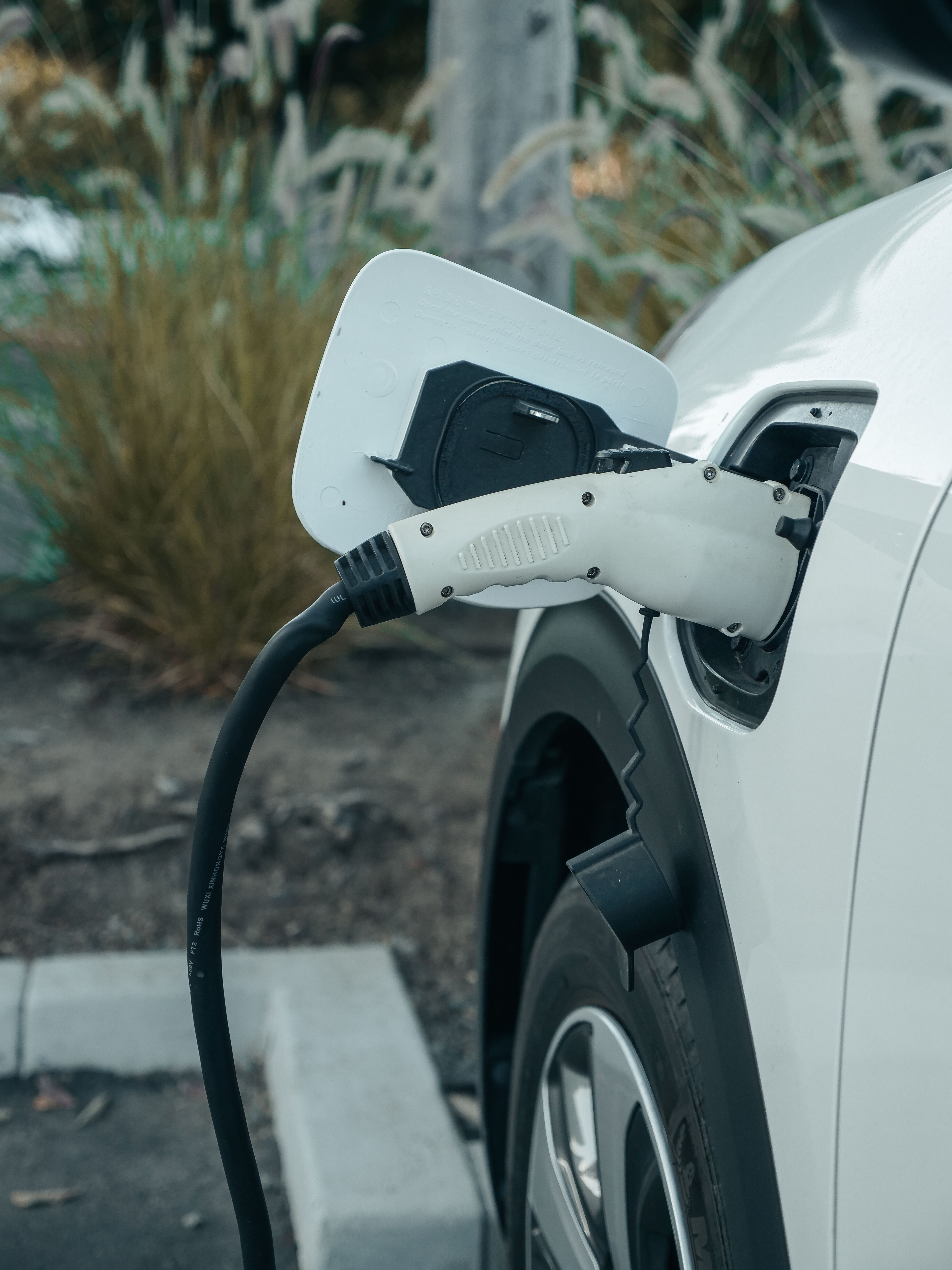 Electric vehicle plugged into a charging station.