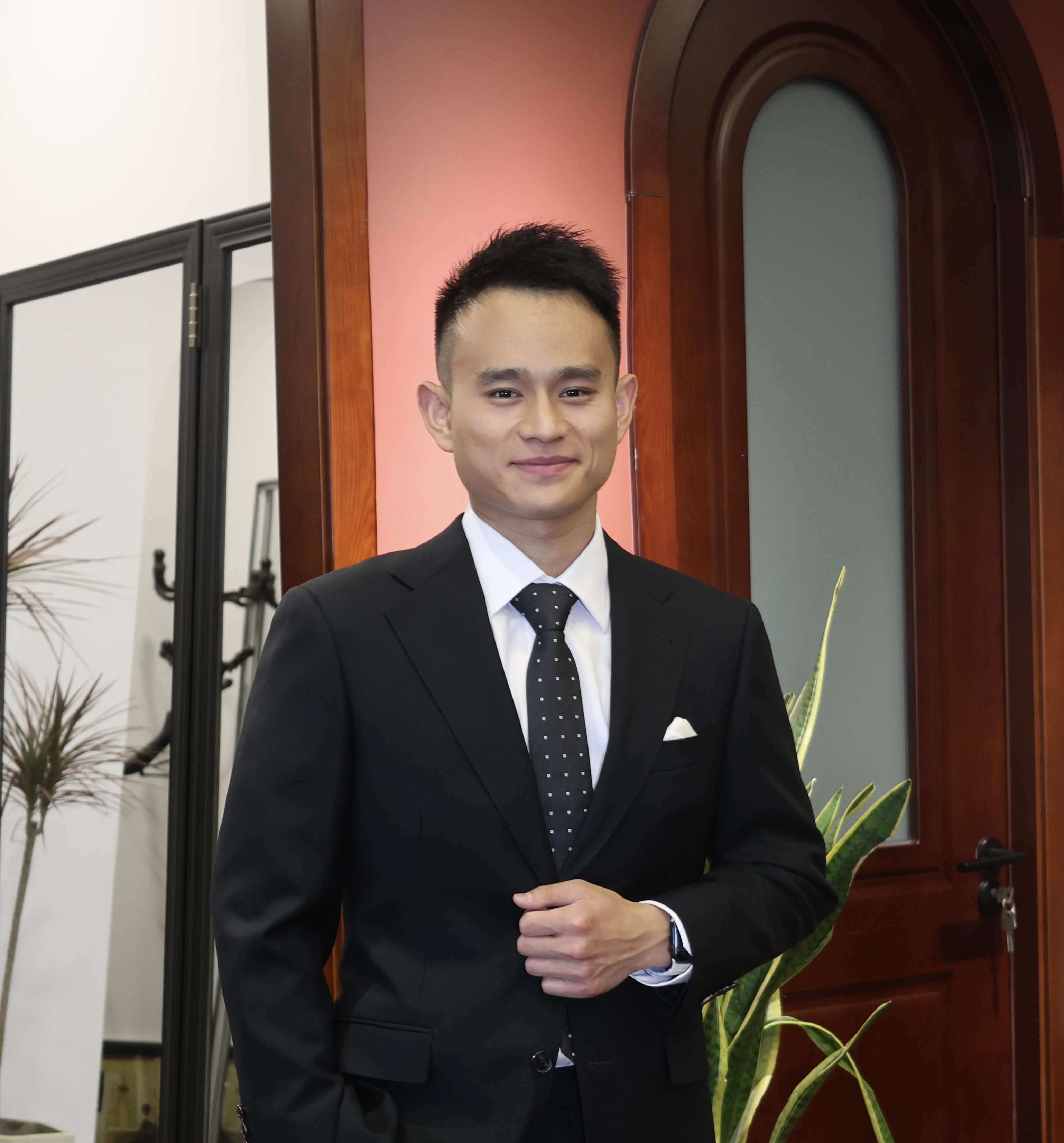 Jerry Fang in suit smiling.