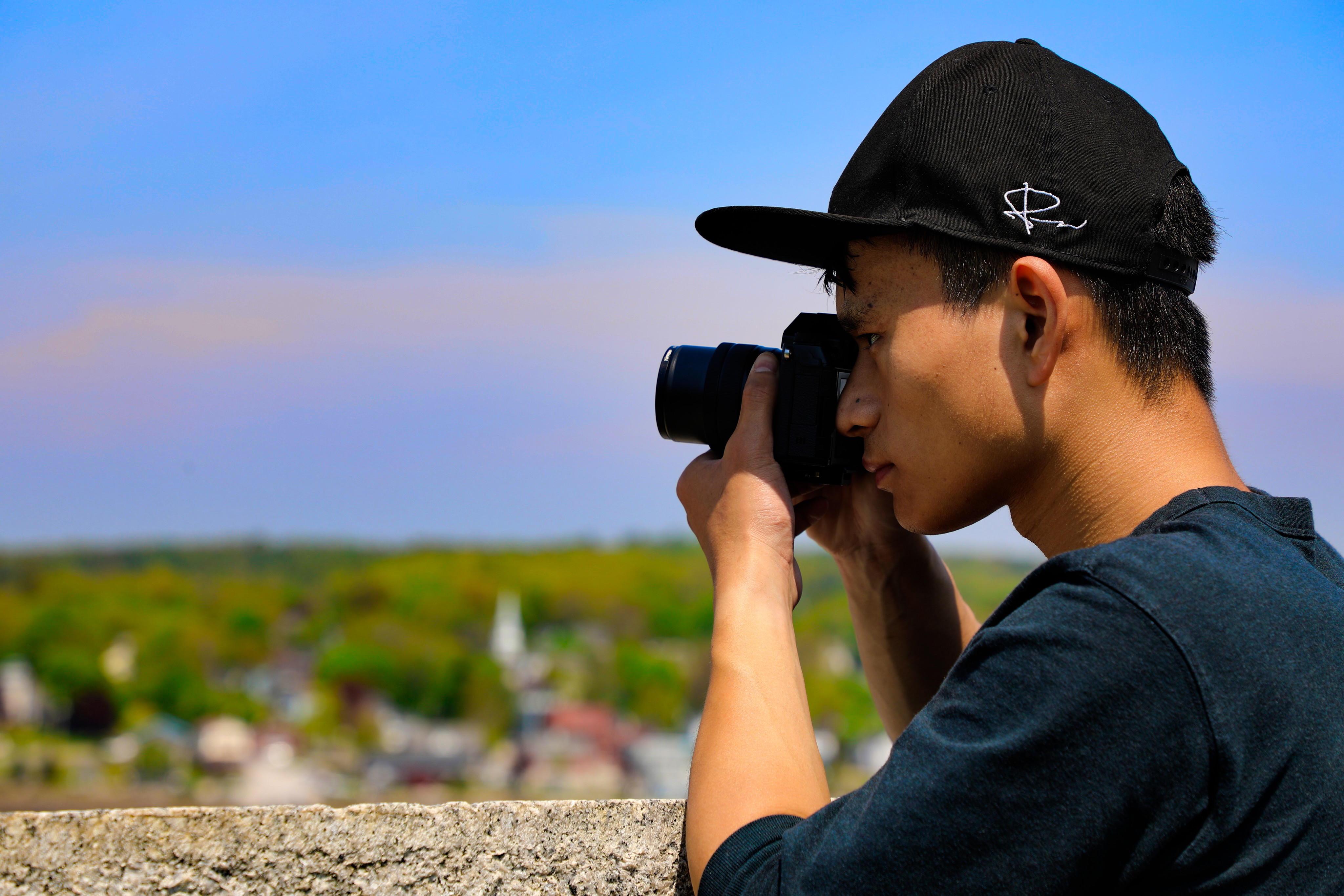 Jerry Fang holds camera to take a photo.