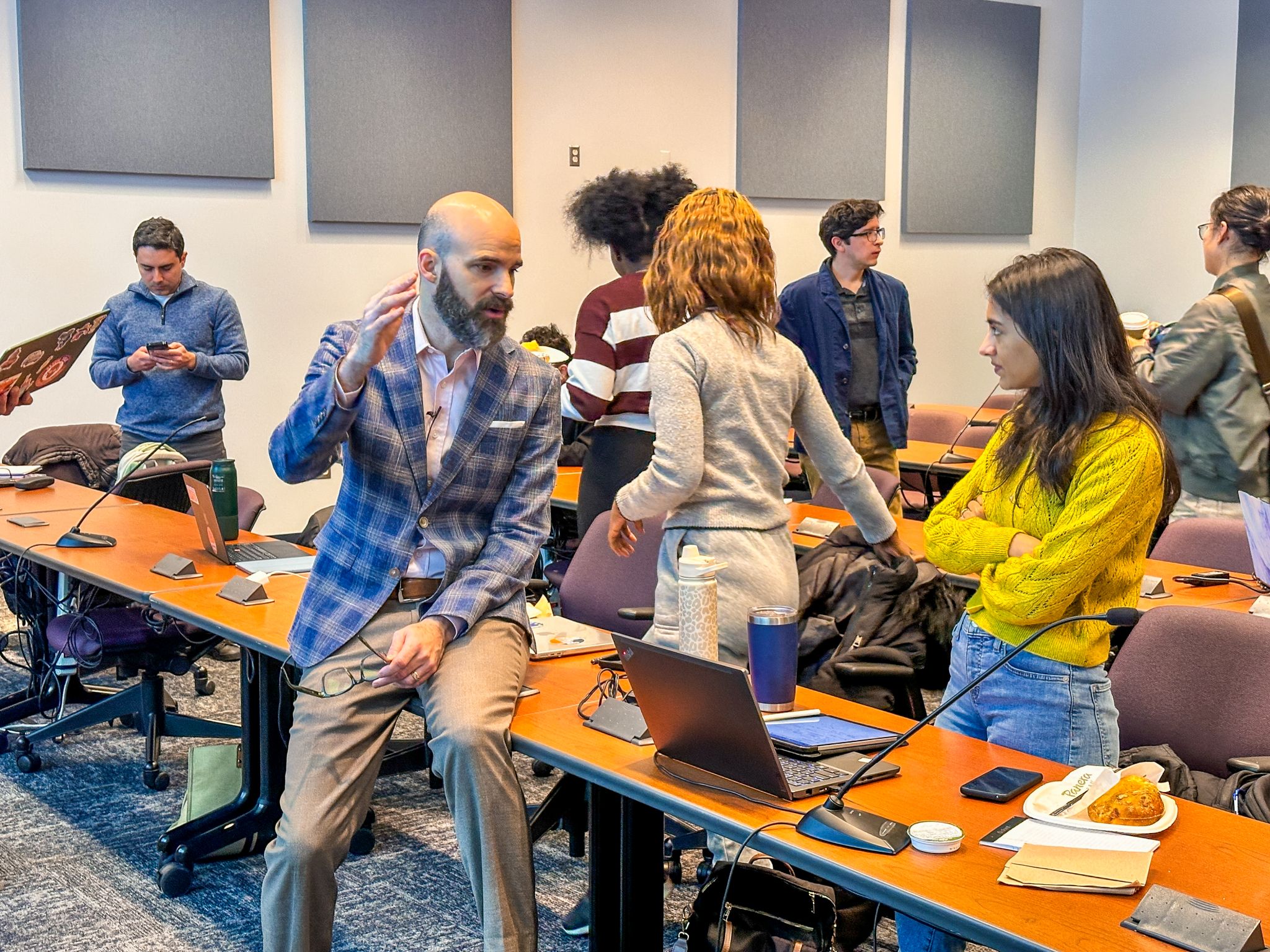 Professor talking to students in a classroom.