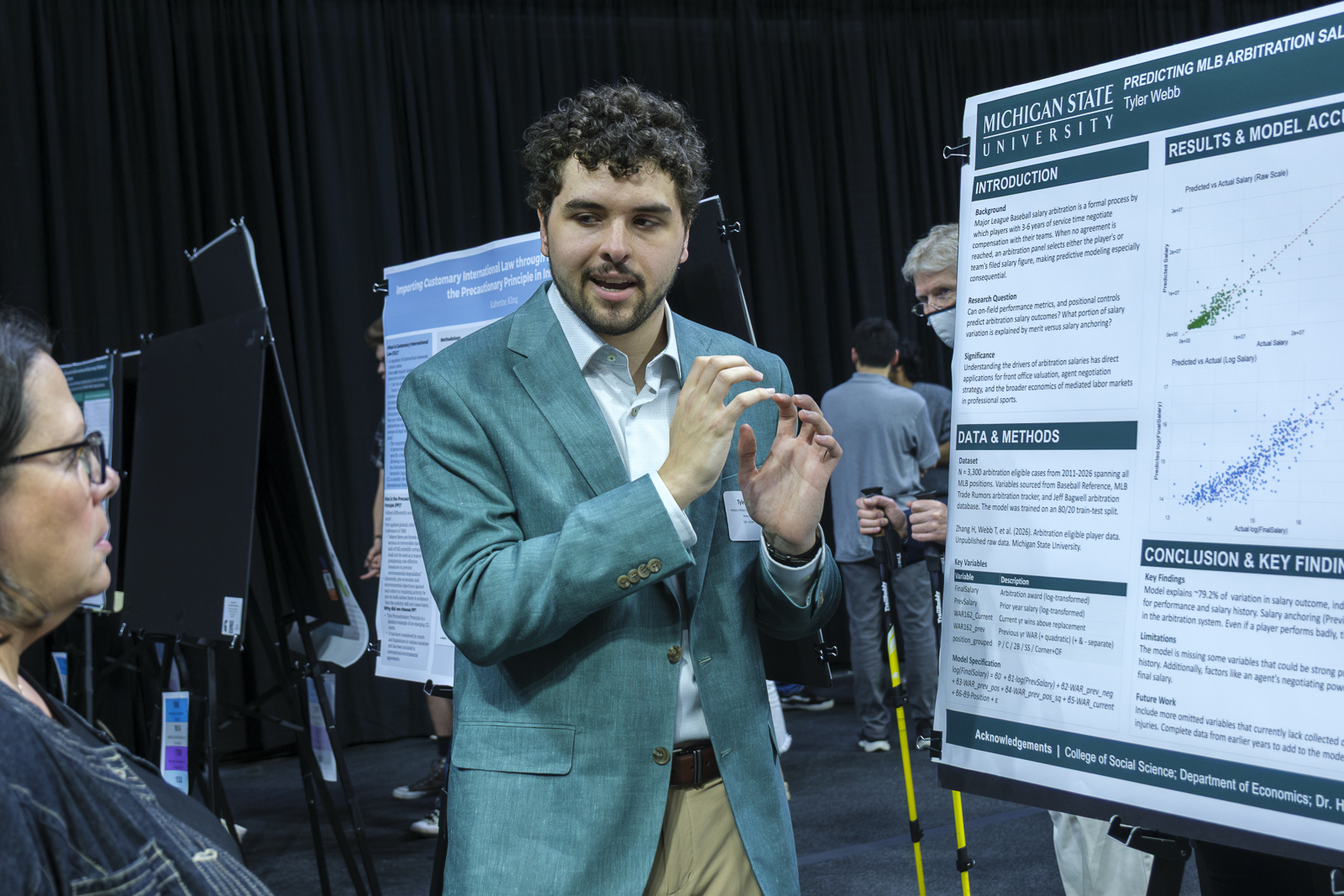 Student presents a research poster.