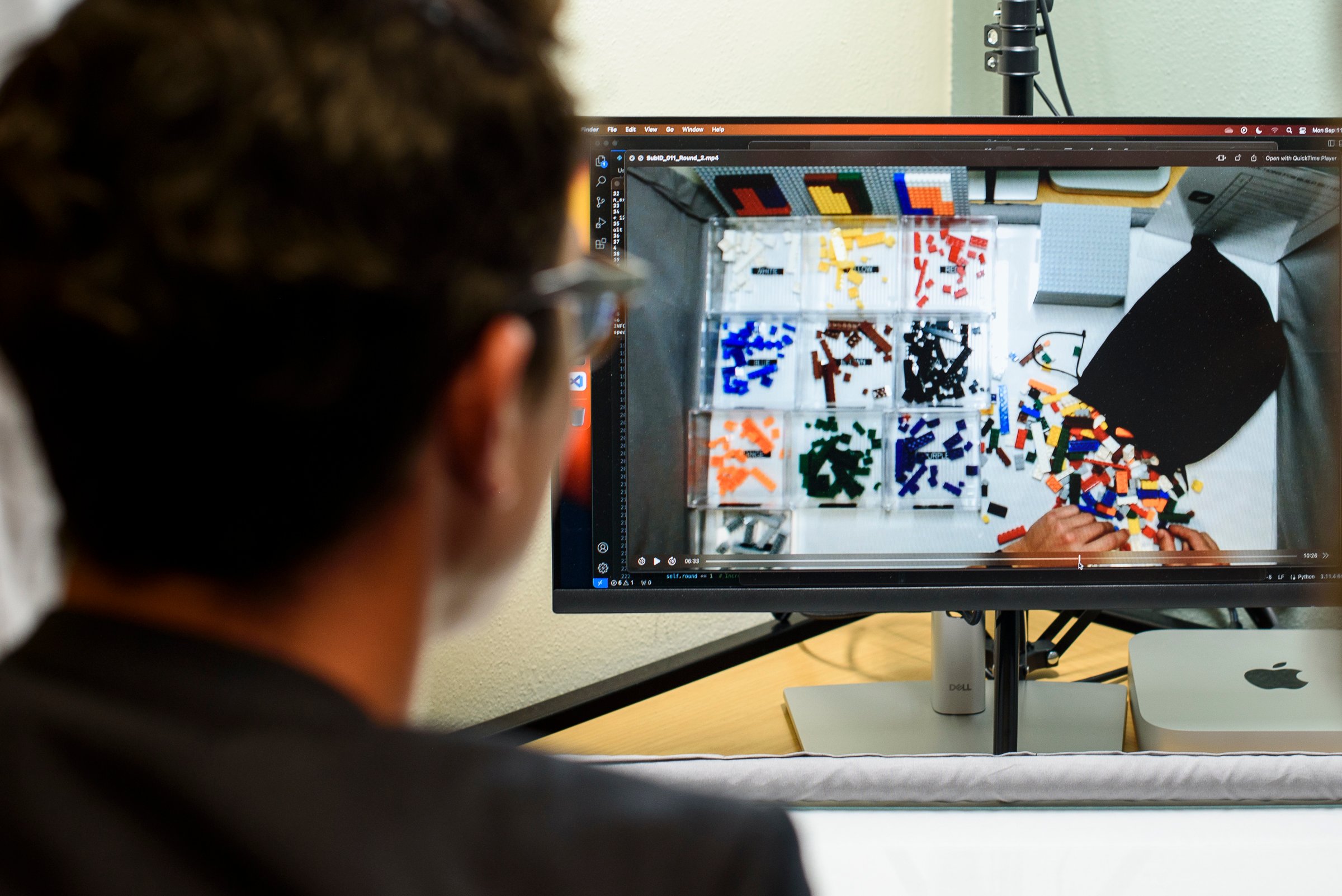 Professor looks at computer recording of a research participant organizing LEGO bricks.