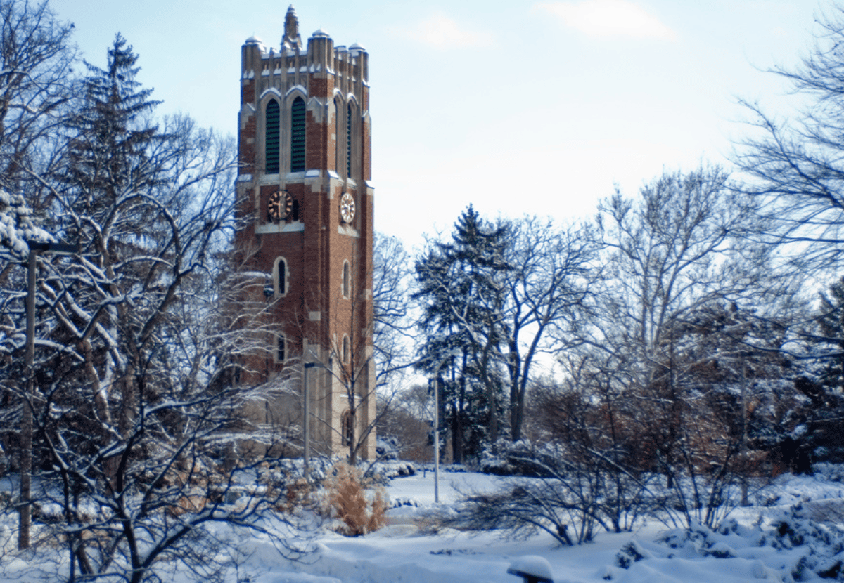 The MSU Beaumont Tower surrounded by snow and winter trees. 