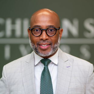 Jerlando F. L. Jackson in a gray suit with a green tie