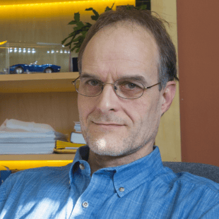 Florian Kagerer wearing a blue shirt and glasses.