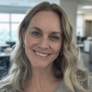 Headshot of Kate Kuzeno wearing a gray shirt. 