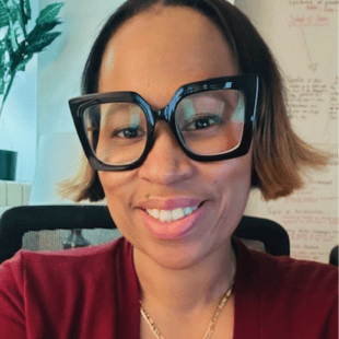Mary Patillo-Dunn wearing a red shirt and dark glasses.