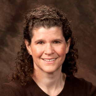 Jennifer Schmidt wearing a dark brown sweater.