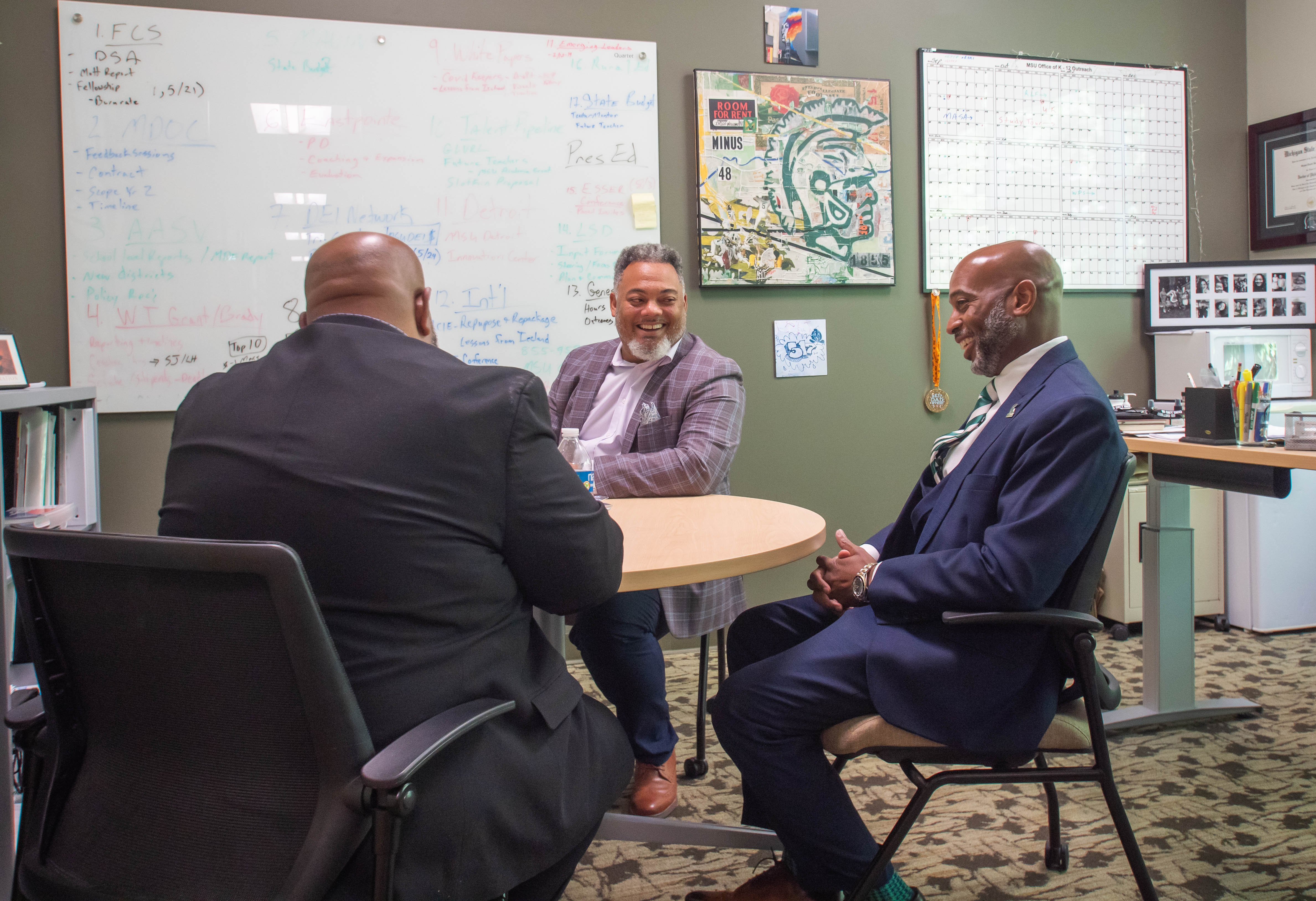 Jackson, Beverly and Watson laugh during a meeting in Erickson Hall.