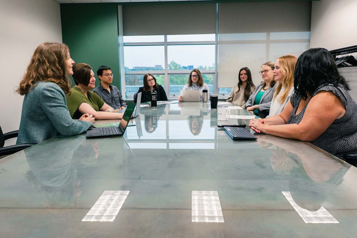 Scholars, staff and students in the Education Policy Innovation Collaborative discuss during a meeting.
