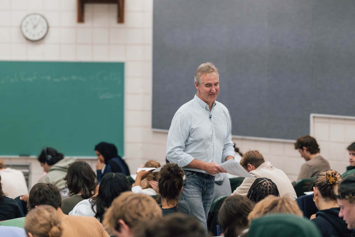 Gabe Ording walks up an aisle during a class session in Kedzie Hall on MSU's campus.