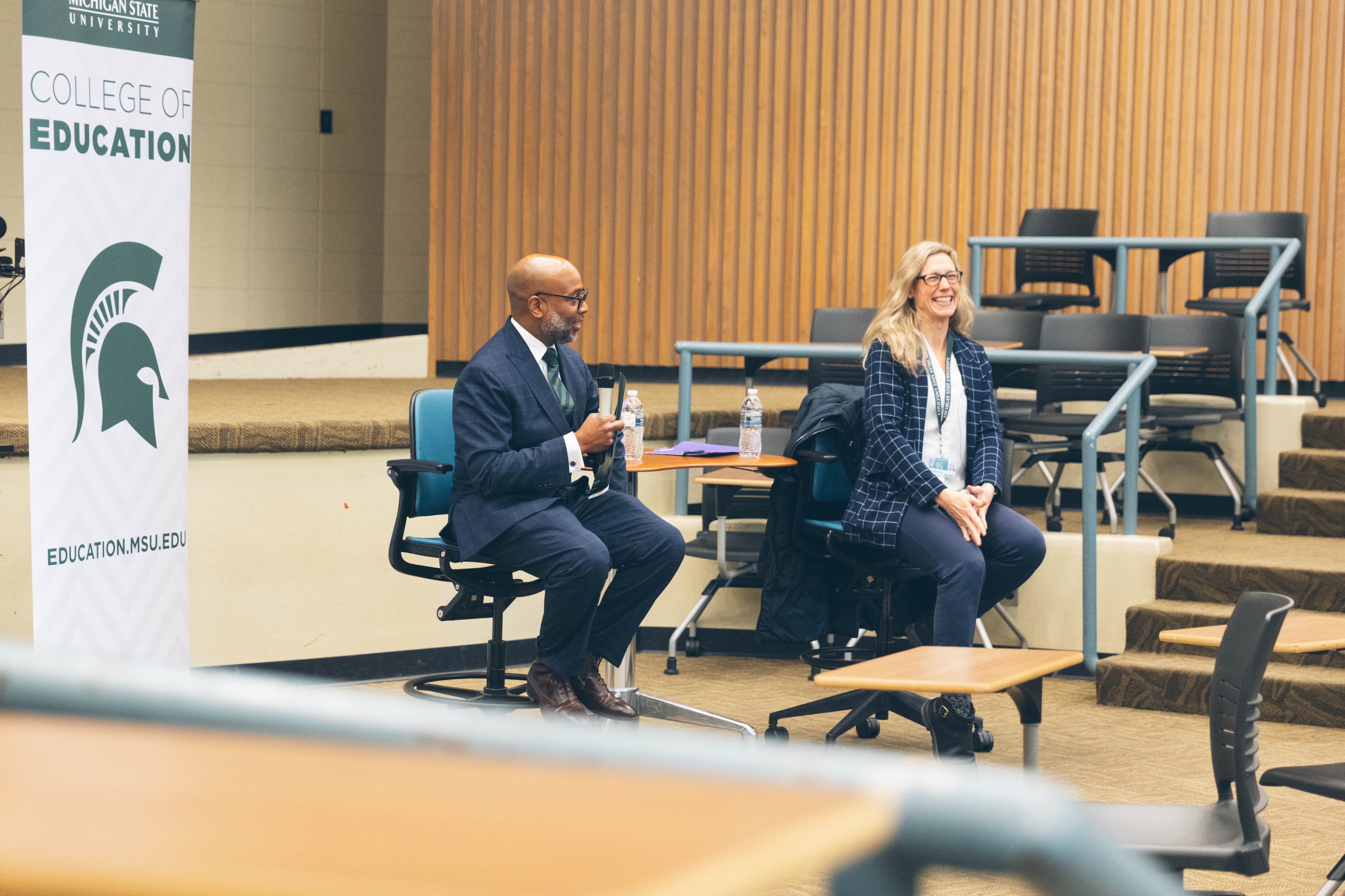 Provost Laura Lee McIntyre and Dean Jerlando Jackson laugh during a meeting in December 2025.