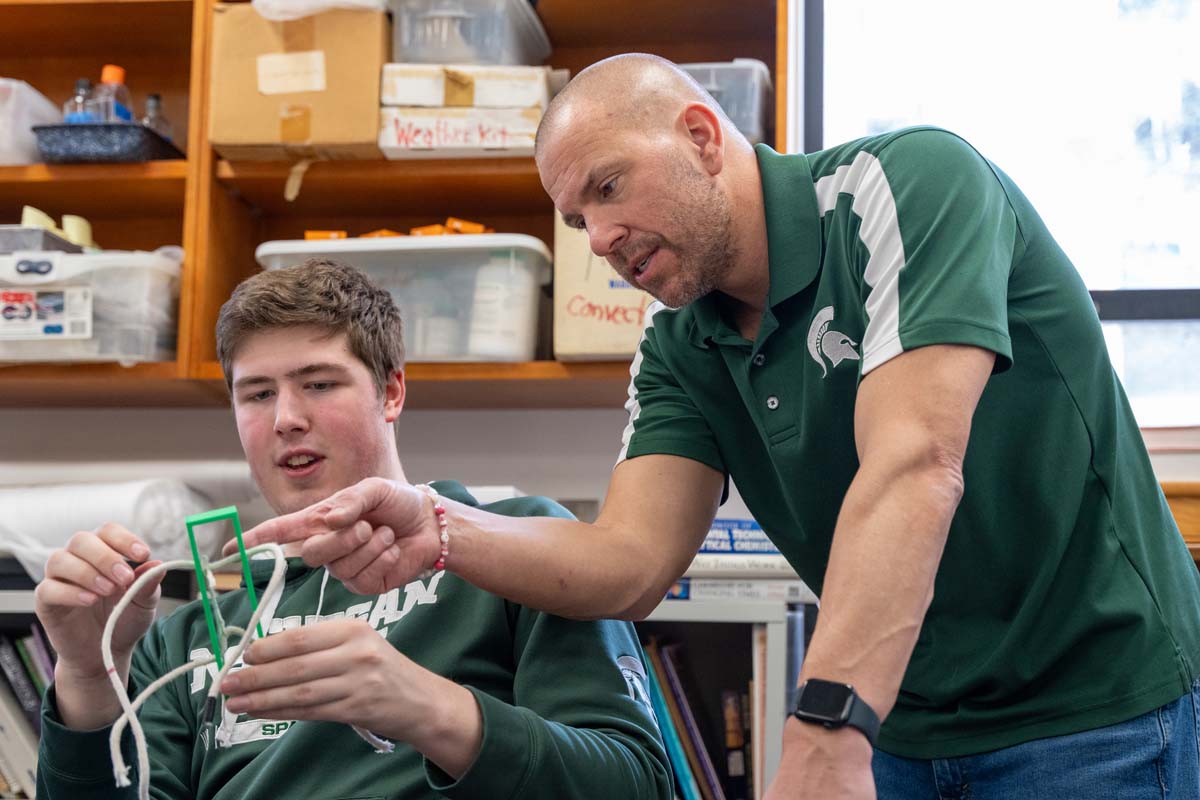 Matt Oney works with a College of Natural Science student during a class. Photo credit: Finn Gomez.