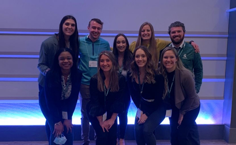 Spartans gather together for a group photo at a conference. 
