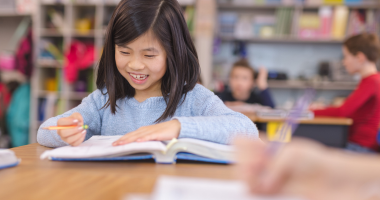 Student smiles while working on a lesson