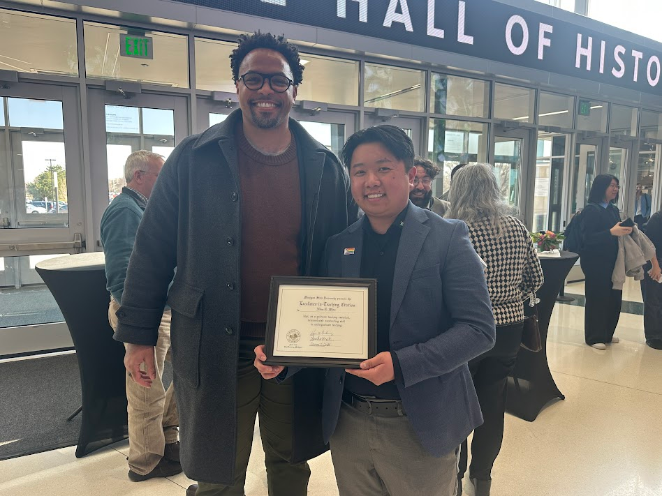 Terrance Burgess and E. Woo pose for a photo at the Breslin Student Events Center during the MSU All-University Awards in 2026.