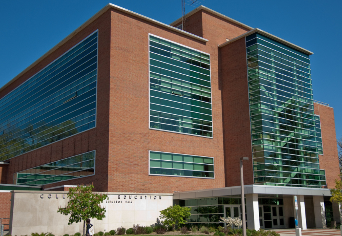 Outside view of Erickson Hall, a brick building with glass windows and stairwell