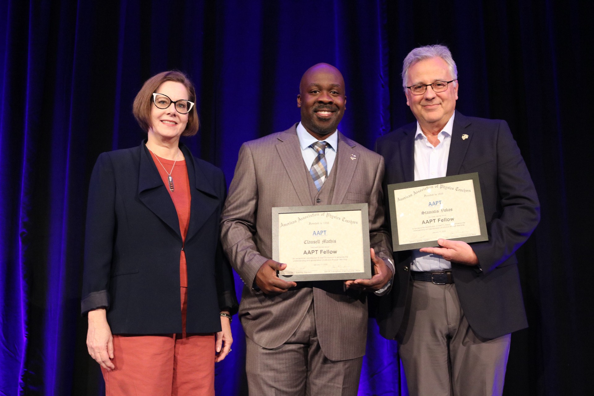 people holding award certificates they received 