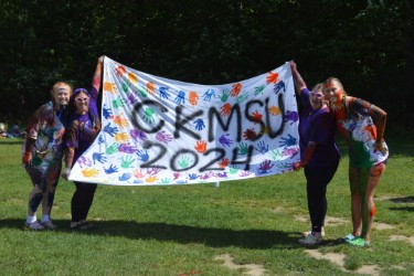 picture of volunteers holding a sign that says CKMSU 2024