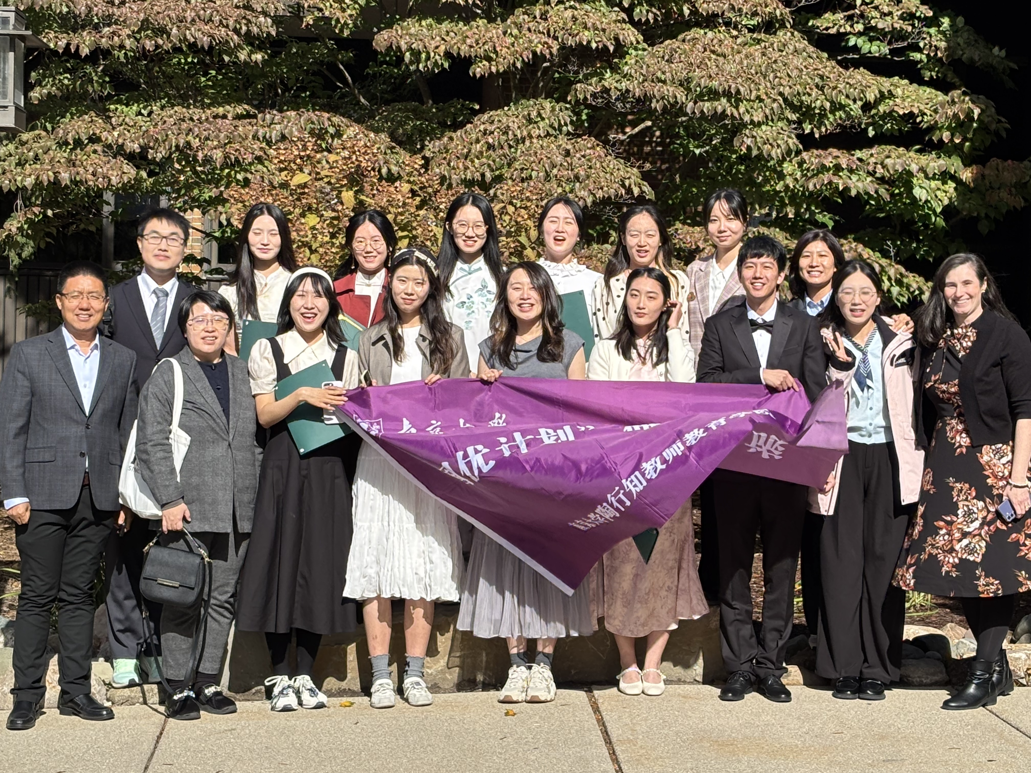group of students holding a purple flag