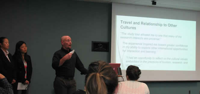 Group presents research at the front of a conference room