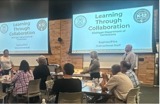 people watching a presentation "learning through collaboration"