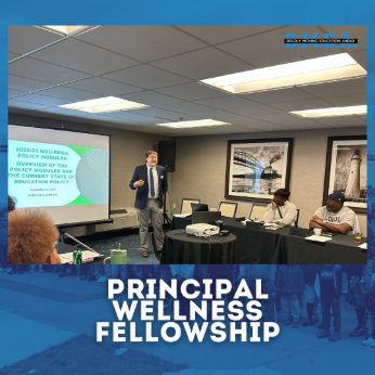 speaker presenting to a panel with presentation slides in the background, there is a blue frame around the picture with text that states "principal wellness fellowship"