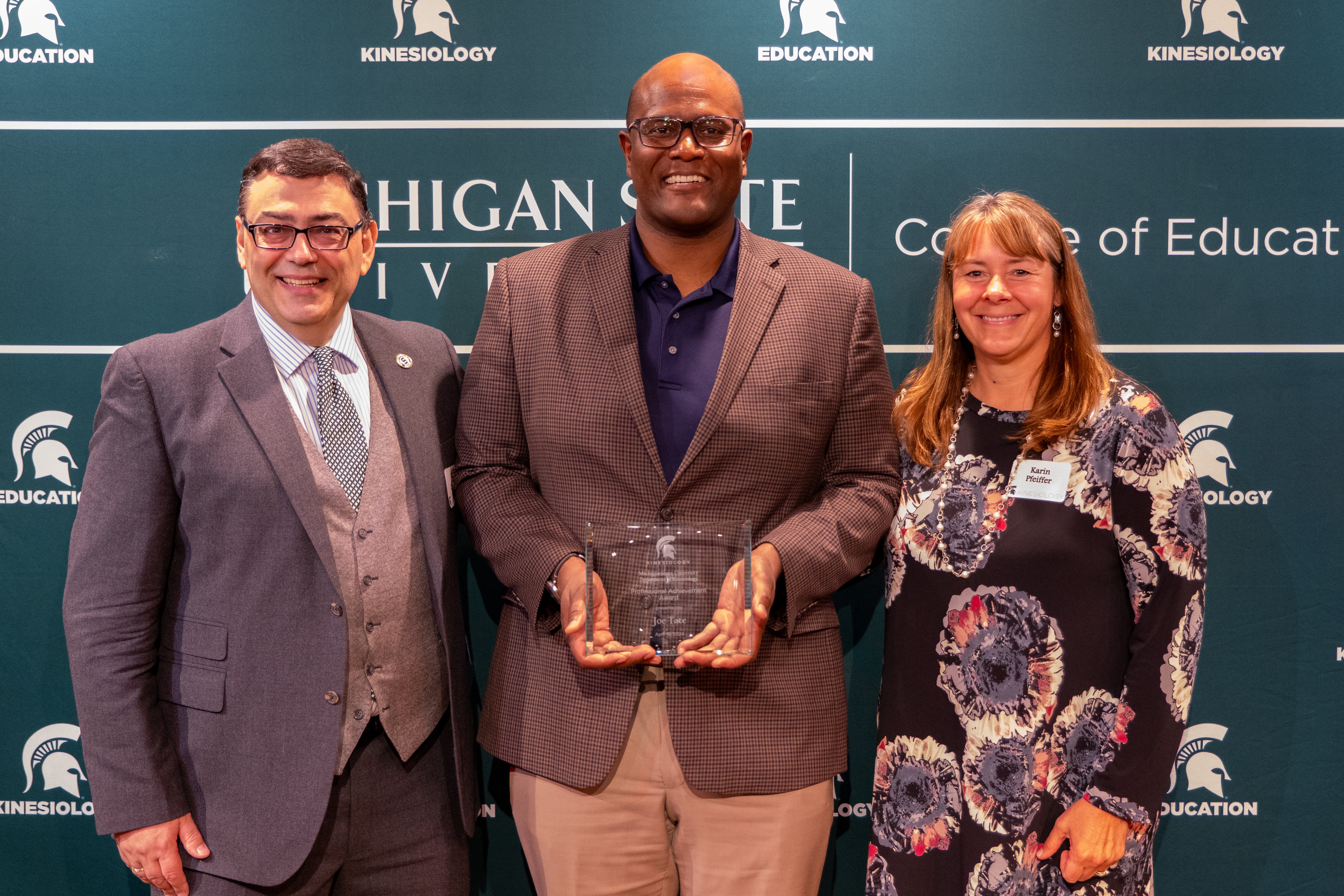 Spartans smile toward the camera (from L to R: Professor Paddy Ekkekakis, alum Joe Tate and Professor Karin Pfeiffer)